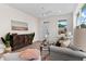 Living room with hardwood floors, a gray couch, and a large piece of artwork at 12078 Lakeshore Way, Oxford, FL 34484