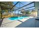 Inviting pool with a screened enclosure and white fence in the backyard at 126 Whitby St, Davenport, FL 33897