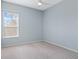 Light blue bedroom with grey carpet and window with blinds at 1515 Cedar Lake Dr, Orlando, FL 32824