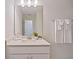 Modern bathroom vanity with a sleek mirror and white cabinets at 165 Golden Noble St, Kissimmee, FL 34747