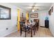Dining room with wood table and chairs, yellow curtains at 2310 Fairgren Ave, Deltona, FL 32738