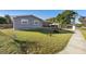 Gray house with front yard, sidewalk, and street view at 2310 Fairgren Ave, Deltona, FL 32738