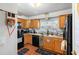 Kitchen with wood cabinets, black appliances, and tile floor at 2310 Fairgren Ave, Deltona, FL 32738