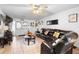 Living room with sectional sofa, ceiling fan, and hardwood floors at 2310 Fairgren Ave, Deltona, FL 32738