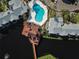 Community pool and surrounding buildings, aerial view at 2504 Woodgate Blvd # 107, Orlando, FL 32822