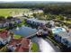 Aerial view of the community featuring a pond, pool, and bridge at 2504 Woodgate Blvd # 107, Orlando, FL 32822