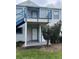 Exterior view of a two-story condo unit with a balcony and stairs at 2504 Woodgate Blvd # 107, Orlando, FL 32822