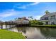 Peaceful waterfront view with a wooden bridge and lush greenery at 2504 Woodgate Blvd # 107, Orlando, FL 32822