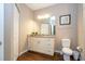 Bathroom with vanity, toilet, and wood-look flooring at 2901 Edenshire Way # 104, Kissimmee, FL 34746