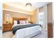 Bedroom with king-size bed, nightstands, and a chandelier at 2901 Edenshire Way # 104, Kissimmee, FL 34746