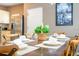 Dining table set for a meal with artwork on the wall at 2901 Edenshire Way # 104, Kissimmee, FL 34746