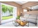 Living room with open patio doors leading to a grassy area at 2901 Edenshire Way # 104, Kissimmee, FL 34746