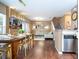 Open concept living and dining area with wood floors and unique lighting at 2901 Edenshire Way # 104, Kissimmee, FL 34746