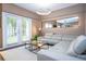 Living room with a large sectional sofa, coffee table, and glass doors to the backyard at 2901 Edenshire Way # 104, Kissimmee, FL 34746