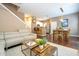 Open-concept living and dining area with modern kitchen and staircase at 2901 Edenshire Way # 104, Kissimmee, FL 34746