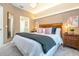 Elegant main bedroom with wooden headboard, plush bedding, and a cozy atmosphere at 2901 Edenshire Way # 104, Kissimmee, FL 34746