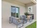 Relaxing covered patio with modern furniture and lush green lawn view at 33283 Country House Dr, Sorrento, FL 32776