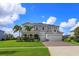 Two-story home with gray siding, solar panels and landscaping at 4150 Sunset Preserve Blvd, Orlando, FL 32820