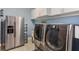 Laundry room with side-by-side washer and dryer and extra fridge at 4150 Sunset Preserve Blvd, Orlando, FL 32820