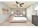 Main bedroom with a large bed, dresser, and ceiling fan at 5427 Hanover Square Dr, St Cloud, FL 34771