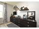 Bedroom with a dresser, TV, and decorative wall shelving at 5427 Hanover Square Dr, St Cloud, FL 34771