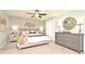Main bedroom with a large bed, dresser, and ceiling fan at 5427 Hanover Square Dr, St Cloud, FL 34771