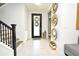 Bright entryway with tile flooring, staircase, and decorative mirrors at 5427 Hanover Square Dr, St Cloud, FL 34771