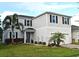 Two-story house with gray siding, landscaping, and a two-car garage at 5427 Hanover Square Dr, St Cloud, FL 34771