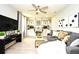 Bright Gathering room features a comfy sofa, built-in shelving, and large TV at 5427 Hanover Square Dr, St Cloud, FL 34771