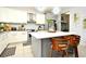 Kitchen island with white quartz countertop and wooden stools at 5427 Hanover Square Dr, St Cloud, FL 34771