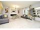 Living room with fireplace, large windows, and a Christmas tree at 5427 Hanover Square Dr, St Cloud, FL 34771