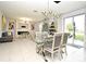 Open living area featuring a fireplace and glass dining table at 5427 Hanover Square Dr, St Cloud, FL 34771