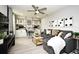 Loft with gray sectional sofa, built-in shelving, and ceiling fan at 5427 Hanover Square Dr, St Cloud, FL 34771