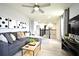 Spacious loft area with gray sectional sofa and ceiling fan at 5427 Hanover Square Dr, St Cloud, FL 34771