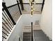 Elegant staircase with black metal railing and light gray walls at 5427 Hanover Square Dr, St Cloud, FL 34771