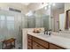 Bathroom with walk-in shower and modern vanity at 12133 Grand Oak Ln, Oxford, FL 34484