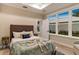 Guest bedroom with wood floors and large windows at 12133 Grand Oak Ln, Oxford, FL 34484