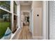 Bright hallway with wood floors and access to other rooms at 12133 Grand Oak Ln, Oxford, FL 34484