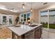 Kitchen island with quartz countertop and stainless steel sink at 12133 Grand Oak Ln, Oxford, FL 34484