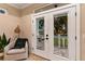 Living room with French doors opening to a patio at 12133 Grand Oak Ln, Oxford, FL 34484