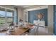 Coastal-themed dining room with a wood table and blue accent wall at 1284 Hanoverian Dr, Lake Alfred, FL 33850