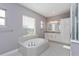 Elegant bathroom featuring a soaking tub, double vanity, and a walk-in shower at 15730 Cutter Sail Pl, Winter Garden, FL 34787