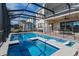 Screened-in pool with spa and safety fence at 15730 Cutter Sail Pl, Winter Garden, FL 34787