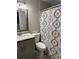 Well-appointed bathroom with a granite countertop vanity and a patterned shower curtain at 1704 Osceola Park Dr, Kissimmee, FL 34741