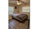 Spacious bedroom with ample natural light, a ceiling fan, and modern wood-look flooring at 1704 Osceola Park Dr, Kissimmee, FL 34741