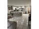 Inviting open-concept kitchen and living area with white tile flooring and ample seating at 1704 Osceola Park Dr, Kissimmee, FL 34741