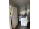 Laundry room with a washing machine and wood-look laminate floors at 1704 Osceola Park Dr, Kissimmee, FL 34741