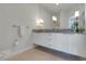 Modern bathroom with double vanity and granite countertop at 17417 Placidity Ave, Clermont, FL 34714