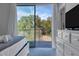 Bedroom with private balcony and serene wooded view at 17417 Placidity Ave, Clermont, FL 34714