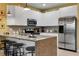 Modern kitchen with stainless steel appliances and breakfast bar at 17417 Placidity Ave, Clermont, FL 34714